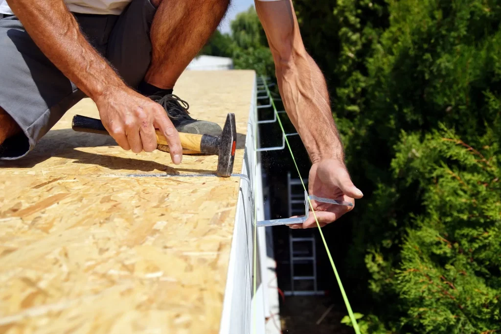 roof worker installing gutter