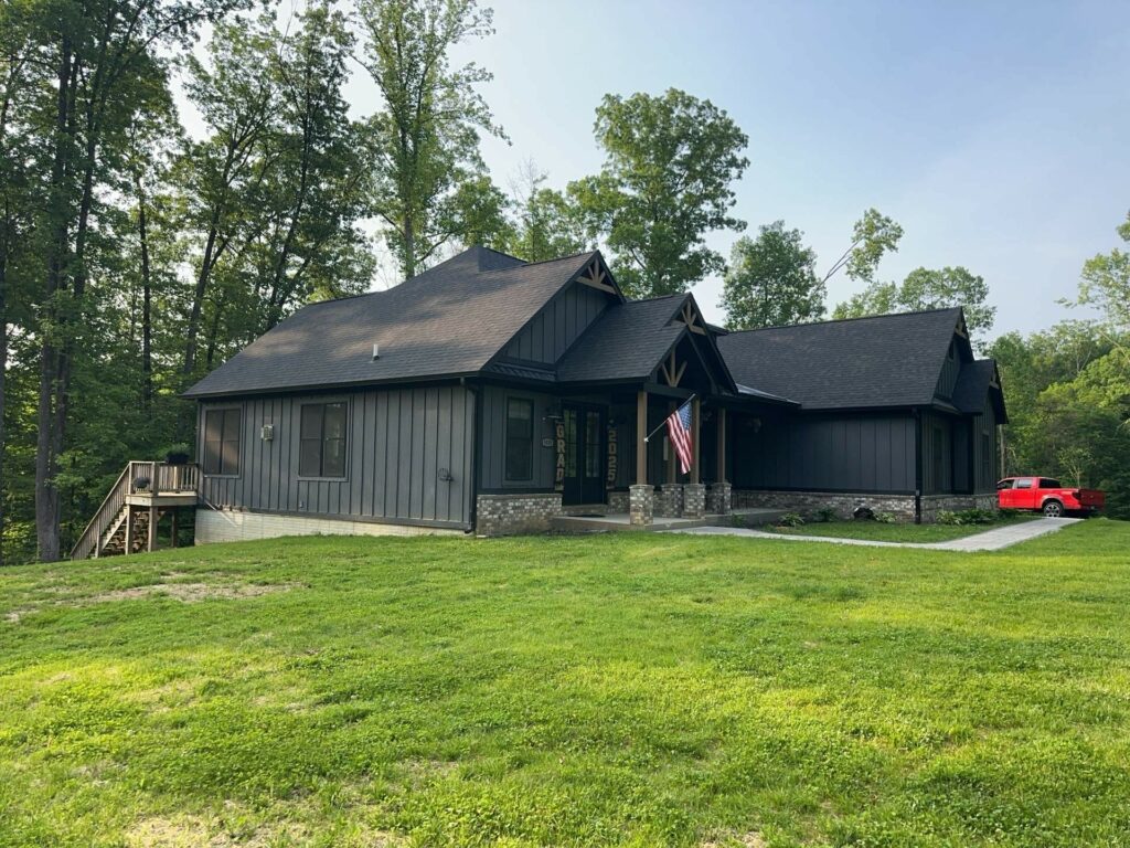 Newly constructed home in Central Indiana featuring a dark gray exterior and a black shingle